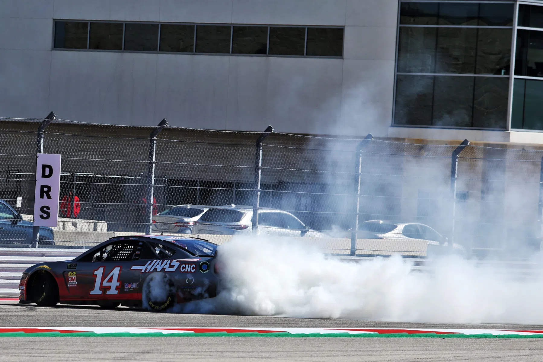 bizarre footage from nascar where a driver throws a bumper